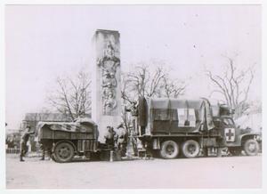 [U.S. Soldiers and Vehicles Under a German War Memorial]