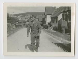 Primary view of object titled '[Edward Siravo Walking Along a Village Street]'.