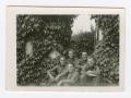 Photograph: [Five Soldiers Sitting Under Ivy-Covered Walls]