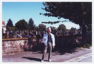 Primary view of object titled '[Man in Front of Cemetery]'.