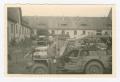 Photograph: [Technical Sergeant Robert Flynn Standing by Line of Jeeps]