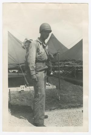 Primary view of object titled '[Private Marcus Dreyfus Standing by Tents]'.