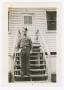 Photograph: [Technician Fifth Grade Crocker Standing on Barracks Steps]