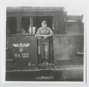 [Soldier Standing in a Railroad Car Entryway]
