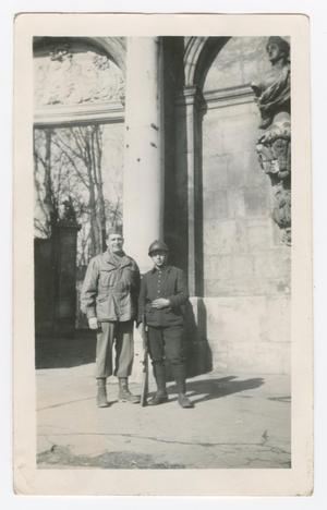 [Dan Melli Standing With a French Soldier Near a Government Building]