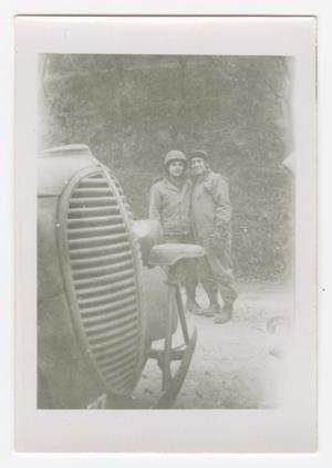 Primary view of object titled '[Smith and Charles Heck Standing Behind a Truck]'.