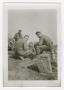 Photograph: [Four Soldiers Gathered Among Stones]