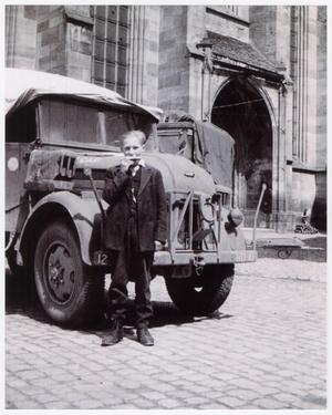 Primary view of object titled '[German Boy in Front of a U.S. Army Truck]'.