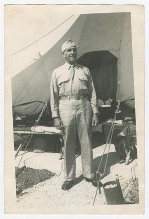 Primary view of object titled '[Nathan Levine Standing by Tents]'.
