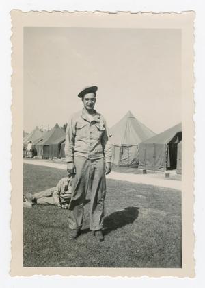 Primary view of object titled '[Joseph Franzone Standing by a Row of Tents]'.