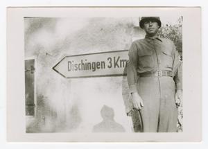 [Sergeant Standing by Sign Pointing to Dischingen, Germany]