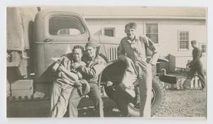 Primary view of object titled '[Three Soldiers Posing by a Truck]'.