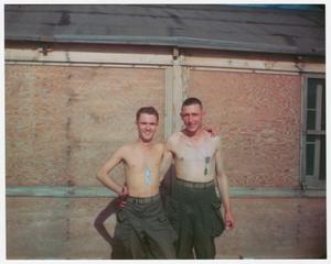 Primary view of object titled '[Zane Jones and Clyde Fleming in Front of Hutment]'.