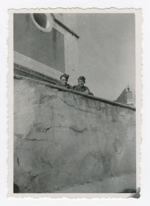 Primary view of object titled '[Howard Fay and Raymond Pieterick Behind a High Wall]'.