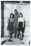 Photograph: [Frank Rumph Standing with Two Young Women]