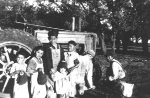 Primary view of object titled '[Kids in front of tractor]'.