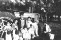 Photograph: [Kids in front of tractor]