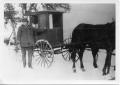 Photograph: [Man with buggy in snow]
