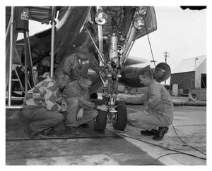 Crew Inspecting Plane Prior to Take-Off