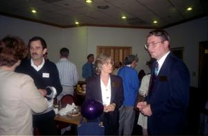 [Photograph of John and Evelyn McAnelly and Earl Garrett at Alumni Meeting]