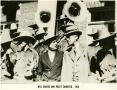 Photograph: [Photograph of Will Rogers and Jefferson Sandefer with Cowboy Band]