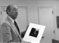 Photograph: [Photograph of Dr. Fletcher with Picture]