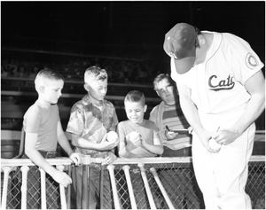 Cats Baseball Player Autographing a Ball