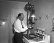 Thumbnail image of item number 1 in: 'Ray Duer using his Photo Enlarger'.
