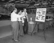 Photograph: [Three Men with Safety Poster and Trophy]