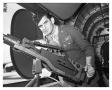 Photograph: [Sergeant Hayduk Posing with Waist Gun]
