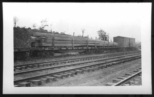 Primary view of object titled '[Railroad Track, Timber on the Train. Location Unknown.]'.