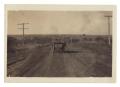 Primary view of [Pierce-Arrow automobile driving on dirt road]