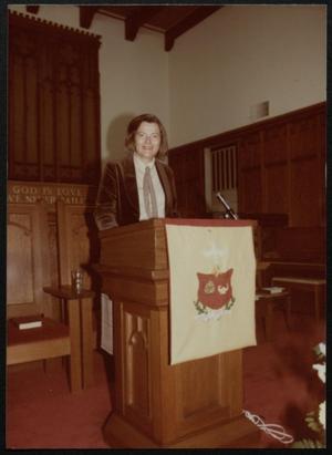 Primary view of object titled '[Woman standing at podium]'.