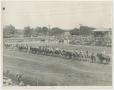 Photograph: [Line of People on Horses at a Rodeo]