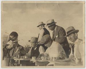 [Photograph of a Group of Men Eating]