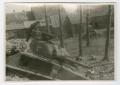 Photograph: [Richard Koos Standing on a Wrecked Tank]
