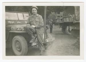 Primary view of object titled '[Edward Scott Sitting on a Jeep]'.