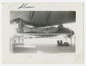 Primary view of object titled '[Melisko Lying on Cot]'.