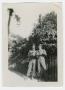 Photograph: [Two Soldiers by a Wrought Iron Fence]