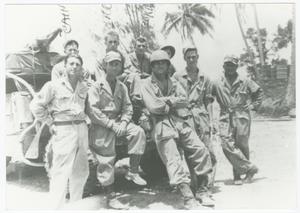 Primary view of object titled '[Nine Soldiers Gathered in Front of an Armored Vehicle]'.