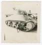 Photograph: [William Giannopoulos Crouching Beside a Tank]