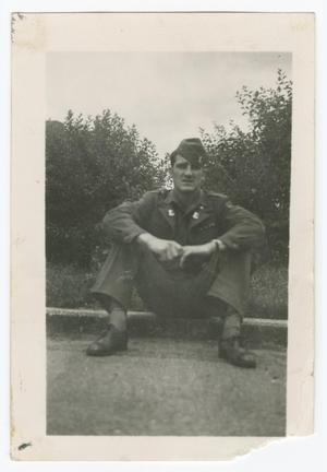 Primary view of object titled '[Ernest Stanczyk Sitting on a Curb]'.