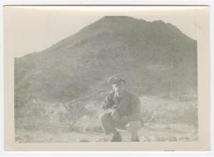[William Giannopoulos Crouching in Front of a Mountain]
