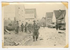Primary view of object titled '[Soldier Reentering Hettstadt, Germany]'.