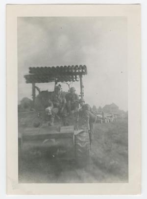 [Three Soldiers Sitting Under a T-34 Calliope Rocket Launcher]
