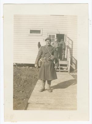 [Edward Scott Standing in Front of a Barracks Building]