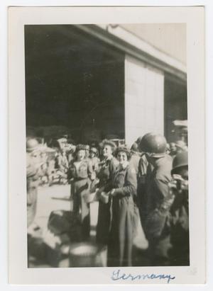 [Three Red Cross Workers Among a Group of Soldiers]
