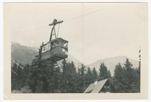 [Cable Car Passing Over a Wooded Area]
