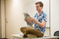 Primary view of [Student with North Texas Daily newspaper]