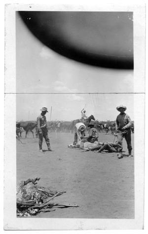 Cowboys Working on an Cow